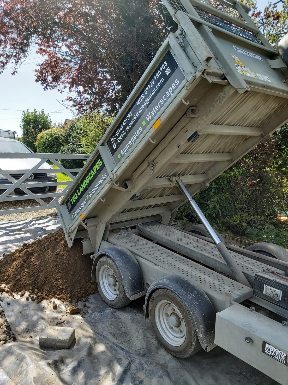 Trailer depositing soil