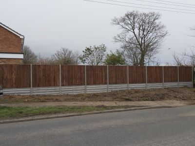 Solid fencing installed with concrete reinforcement