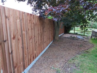 Shingled area next to a wooden fence