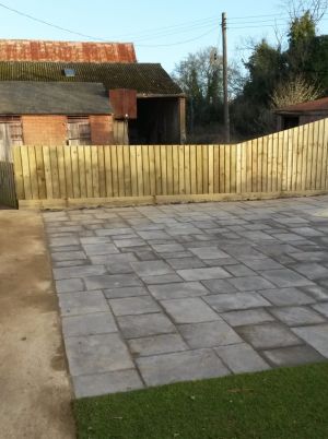 Paved area with smart lawn and wooden fence