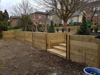 Raised wooden planter split by tiled steps