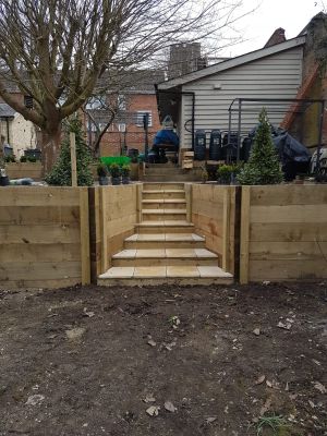 Raised wooden planter split by tiled steps