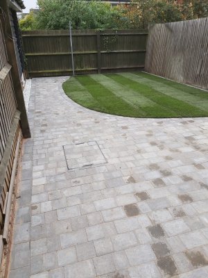 Patio with small tiles next to lawn